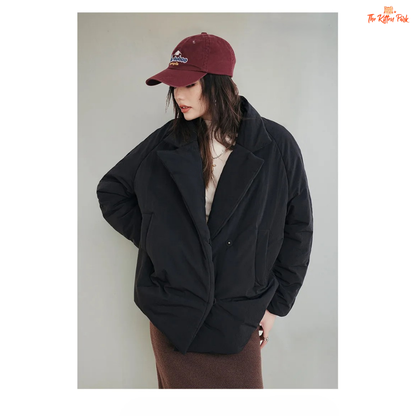 A black cotton-padded puffer coat for women with a collared design, thick warmth, covered button full opening, polyester fiber filling, and regular loose streetwear fit.