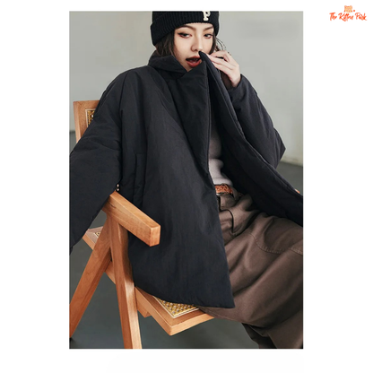 A black cotton-padded puffer coat for women with a collared design, thick warmth, covered button full opening, polyester fiber filling, and regular loose streetwear fit.