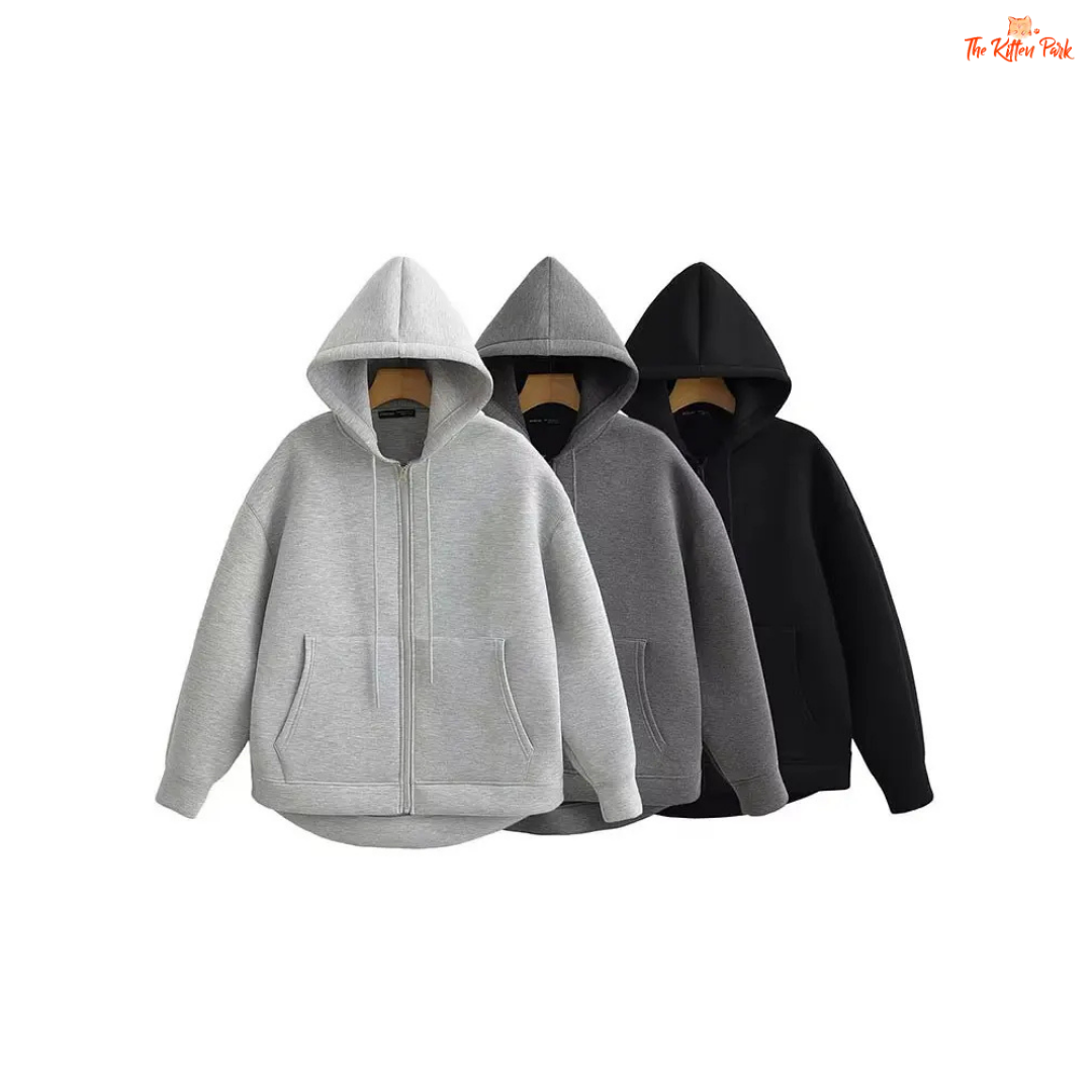 A gray hooded zipper jacket for women with soft polyester fabric, regular fit, full sleeves, pockets, and a casual office-ready design.