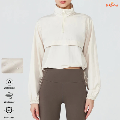 Women's lightweight quarter-zip windbreaker jacket with UPF50+ sun protection, breathable waterproof nylon, and cropped sporty design.