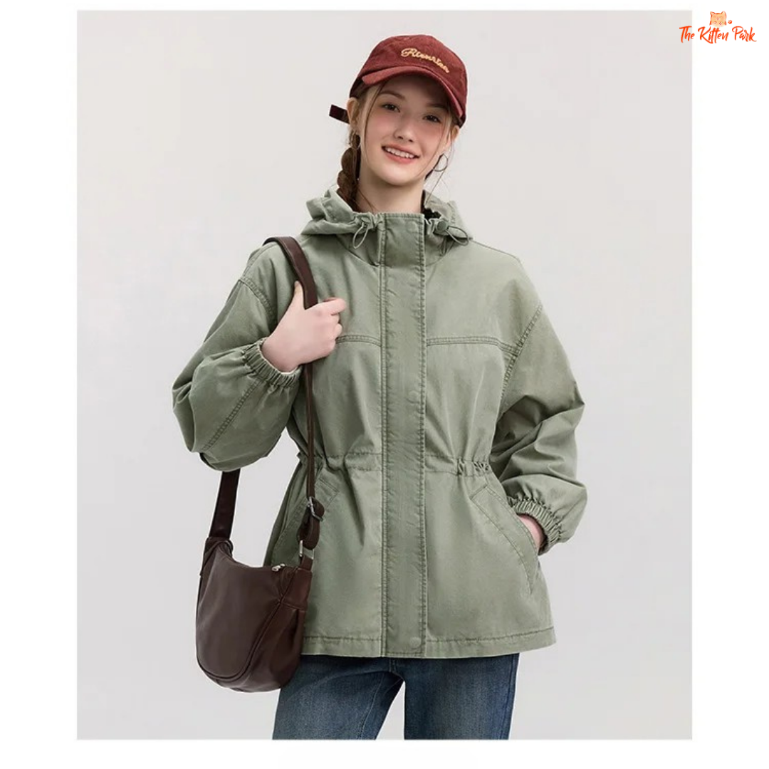 A women’s mid-length hooded denim jacket with loose fit, zipper full opening, waist-cinching detail, and cotton–polyester blend for spring and summer casual wear.