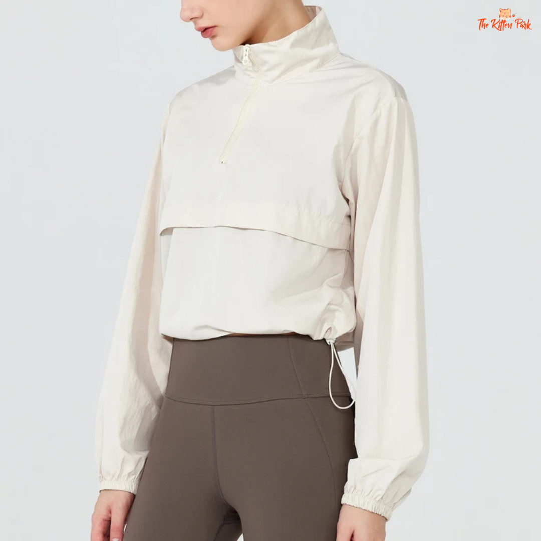Women's lightweight quarter-zip windbreaker jacket with UPF50+ sun protection, breathable waterproof nylon, and cropped sporty design.