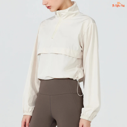 Women's lightweight quarter-zip windbreaker jacket with UPF50+ sun protection, breathable waterproof nylon, and cropped sporty design.
