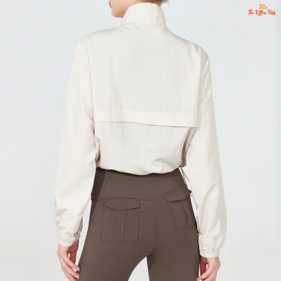 Women's lightweight quarter-zip windbreaker jacket with UPF50+ sun protection, breathable waterproof nylon, and cropped sporty design.