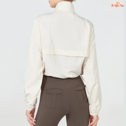 Women's lightweight quarter-zip windbreaker jacket with UPF50+ sun protection, breathable waterproof nylon, and cropped sporty design.