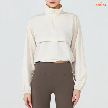 Women's lightweight quarter-zip windbreaker jacket with UPF50+ sun protection, breathable waterproof nylon, and cropped sporty design.