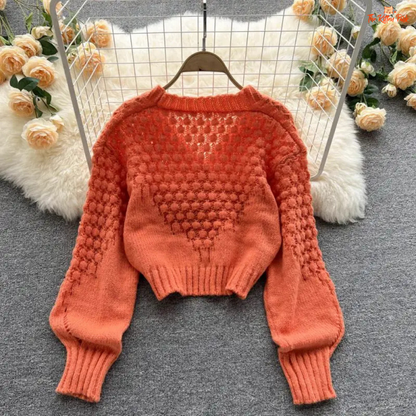 A loose-fit women’s knit cardigan with lantern sleeves, V-neck, hollow-out detailing, and single-breasted closure, designed for autumn/winter 2026.