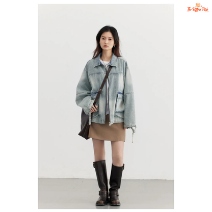 A women’s loose blue denim jacket made of cotton, featuring a turn-down collar, zipper closure, full sleeves, and pockets for a casual spring/autumn look.