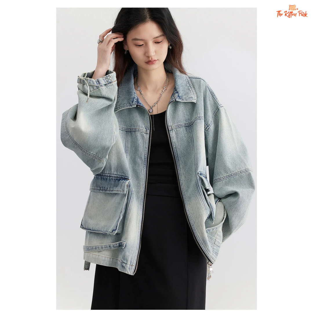 A women’s loose blue denim jacket made of cotton, featuring a turn-down collar, zipper closure, full sleeves, and pockets for a casual spring/autumn look.