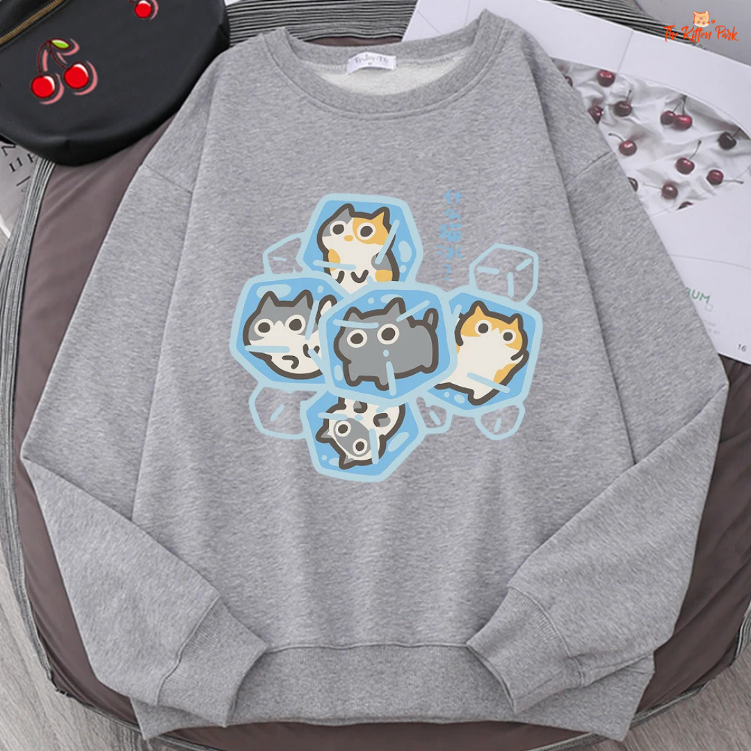 Gray sweatshirt with cartoon cat design on a brown surface