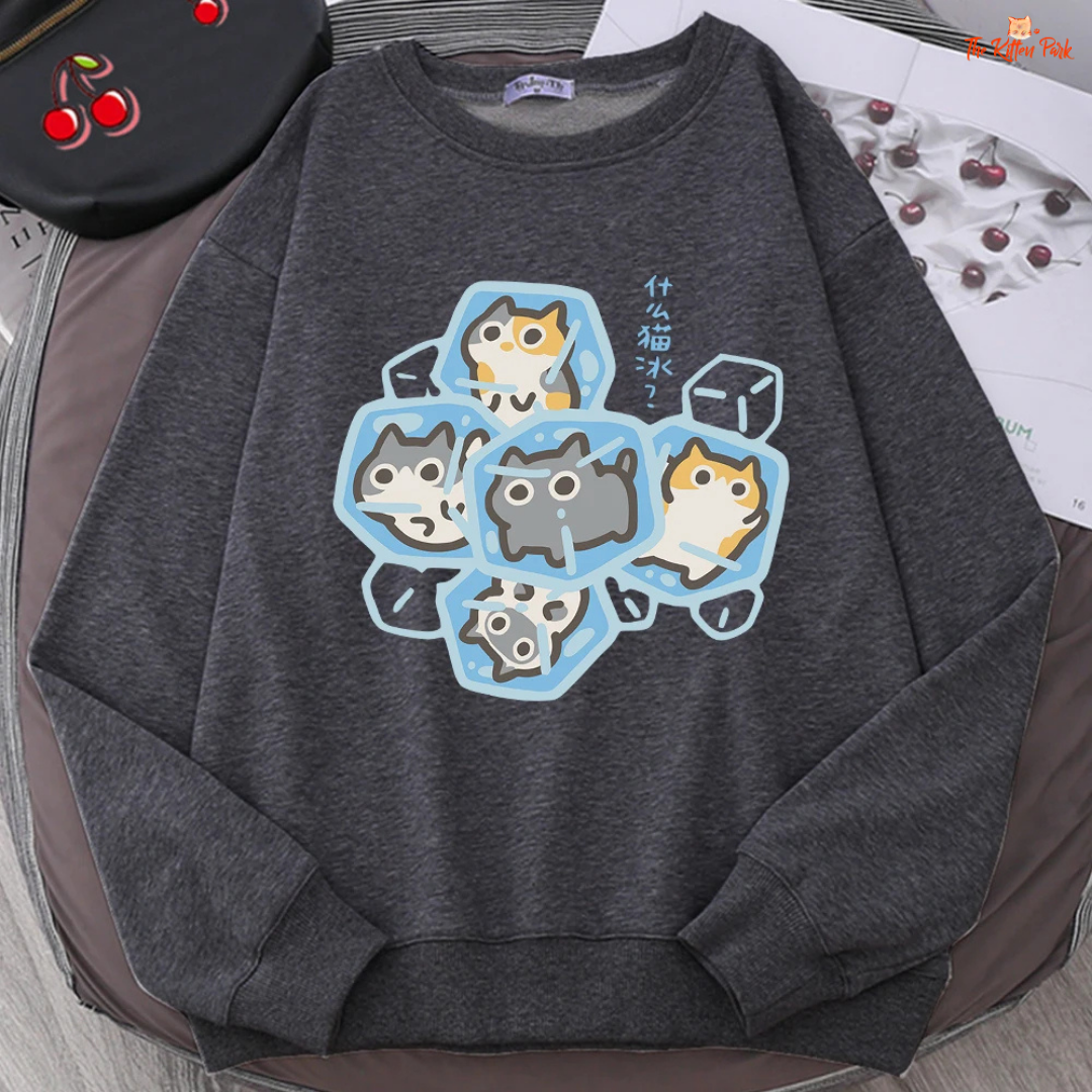 Dark gray sweatshirt with cartoon cat design on a surface