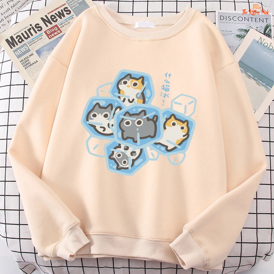 Beige sweatshirt with cartoon cat design on a checkered background
