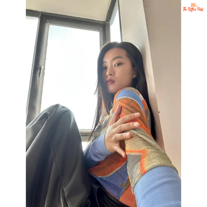 Y2K-style abstract patchwork mesh top with long sleeves and slim fit, combining soft blue and orange tones for a bold streetwear statement.