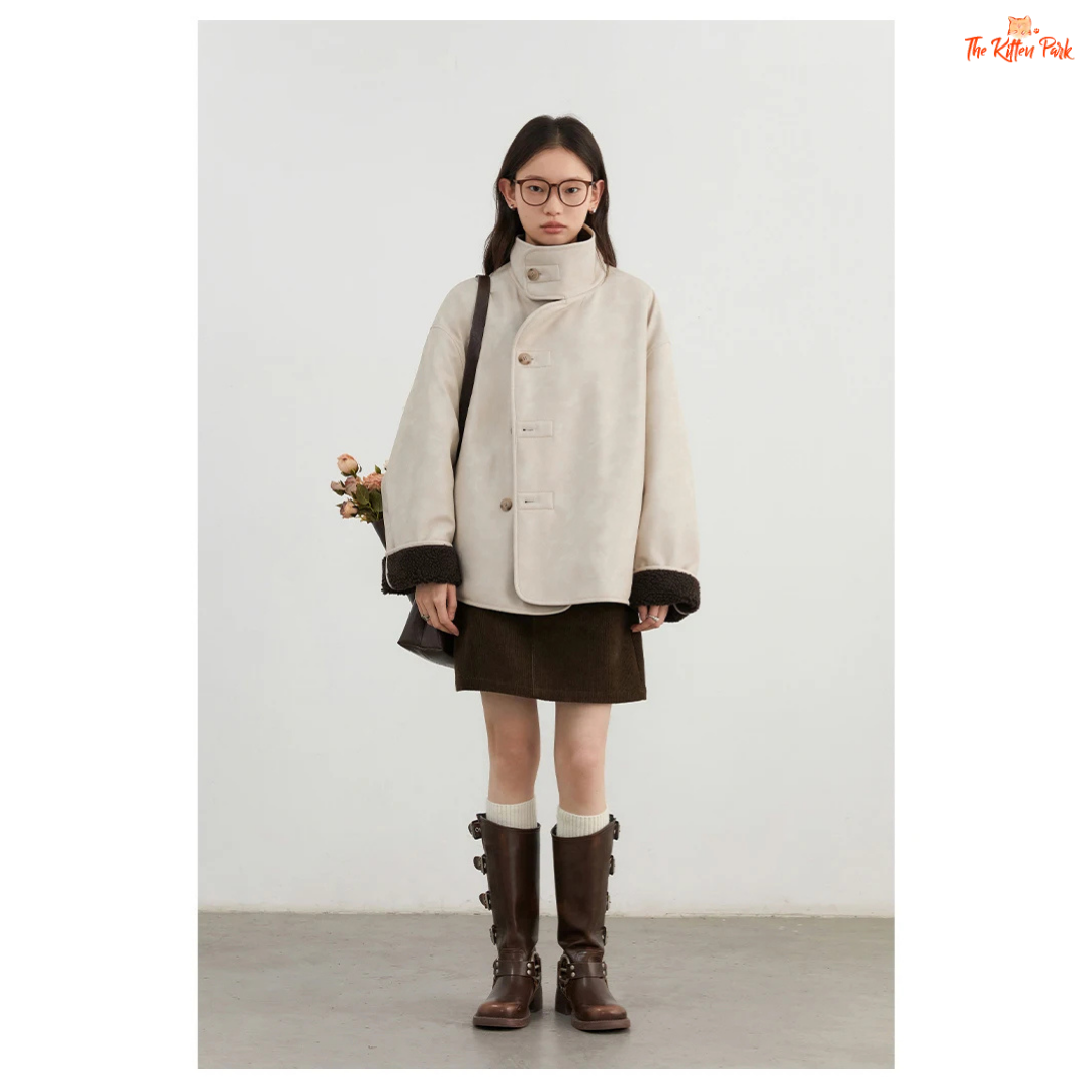 Reversible faux lamb fur jacket for women with patchwork design, turtleneck collar, and single-breasted closure for warm winter streetwear style.