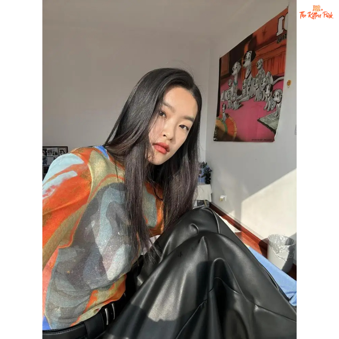 Y2K-style abstract patchwork mesh top with long sleeves and slim fit, combining soft blue and orange tones for a bold streetwear statement.