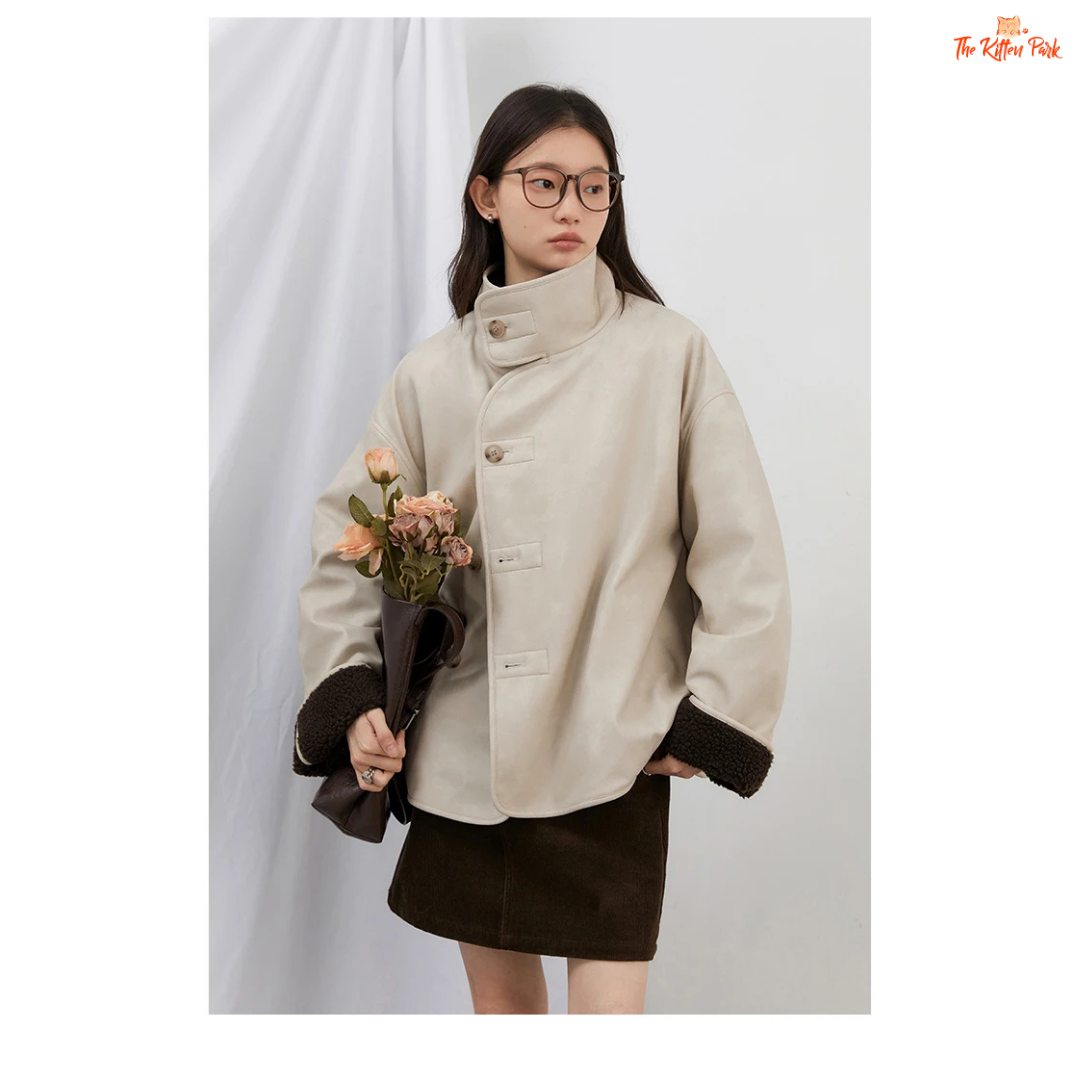 Reversible faux lamb fur jacket for women with patchwork design, turtleneck collar, and single-breasted closure for warm winter streetwear style.