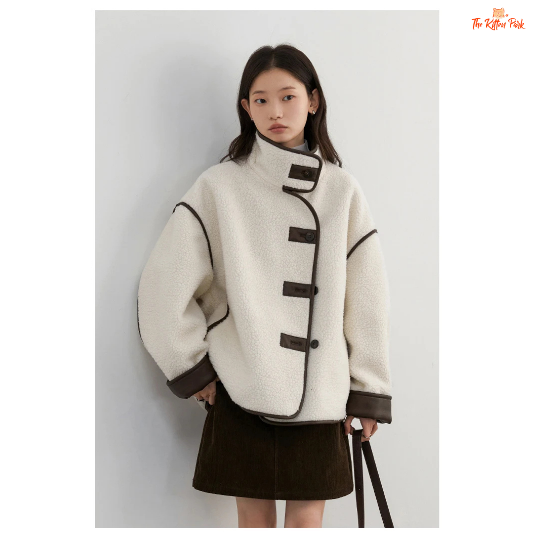 Reversible faux lamb fur jacket for women with patchwork design, turtleneck collar, and single-breasted closure for warm winter streetwear style.