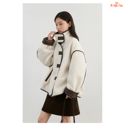 Reversible faux lamb fur jacket for women with patchwork design, turtleneck collar, and single-breasted closure for warm winter streetwear style.