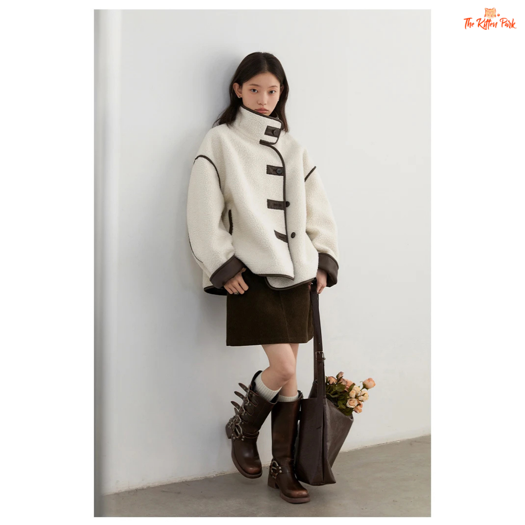 Reversible faux lamb fur jacket for women with patchwork design, turtleneck collar, and single-breasted closure for warm winter streetwear style.