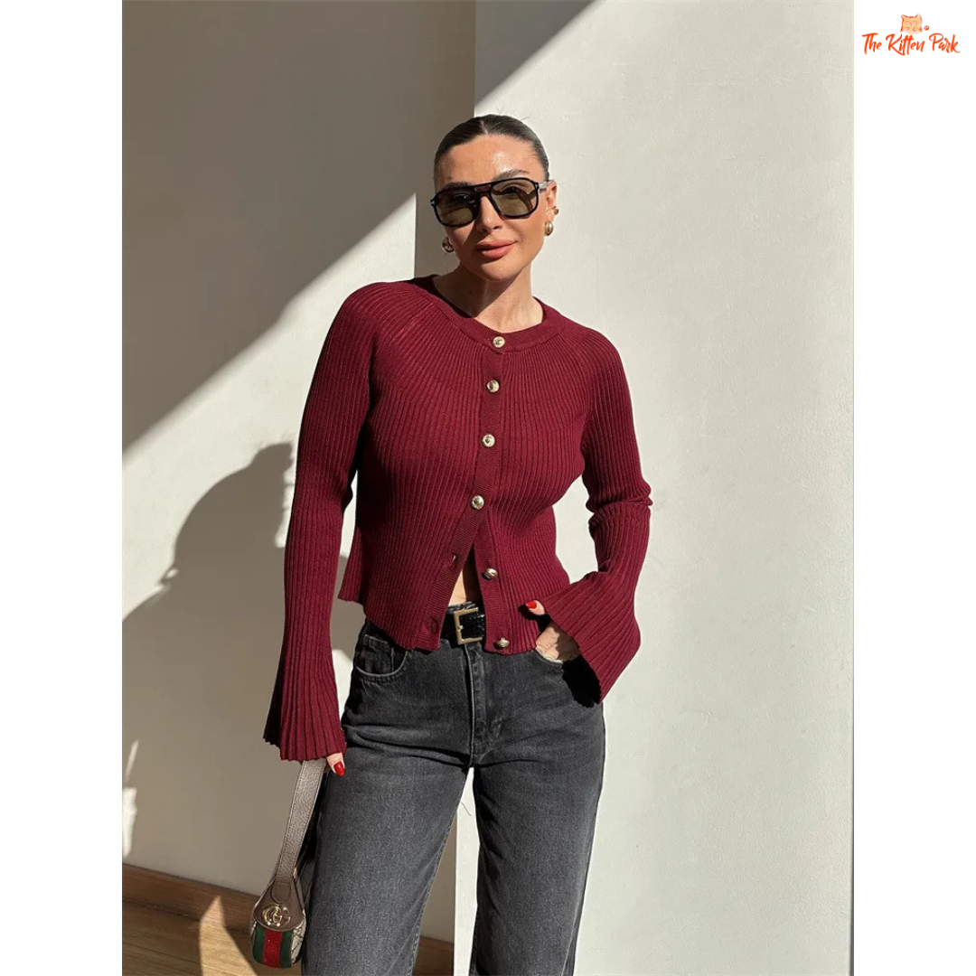 A women’s ribbed knit slim-fit cardigan with long sleeves, flare cuffs, and button closure, styled for chic high-street fashion.