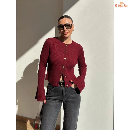 A women’s ribbed knit slim-fit cardigan with long sleeves, flare cuffs, and button closure, styled for chic high-street fashion.