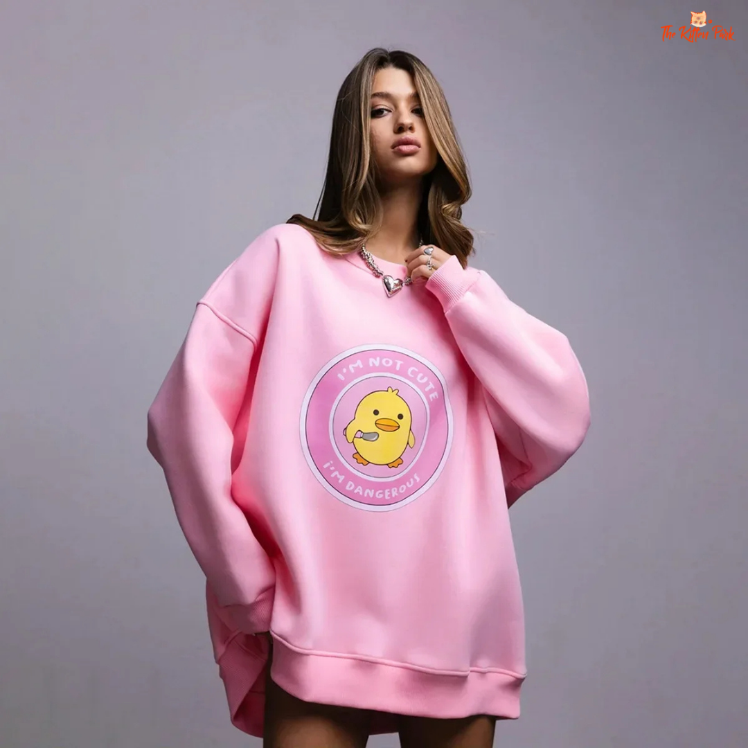 A women’s oversized cotton pullover sweatshirt with hooded collar, drop sleeves, and print design, styled for autumn/winter casual wear.