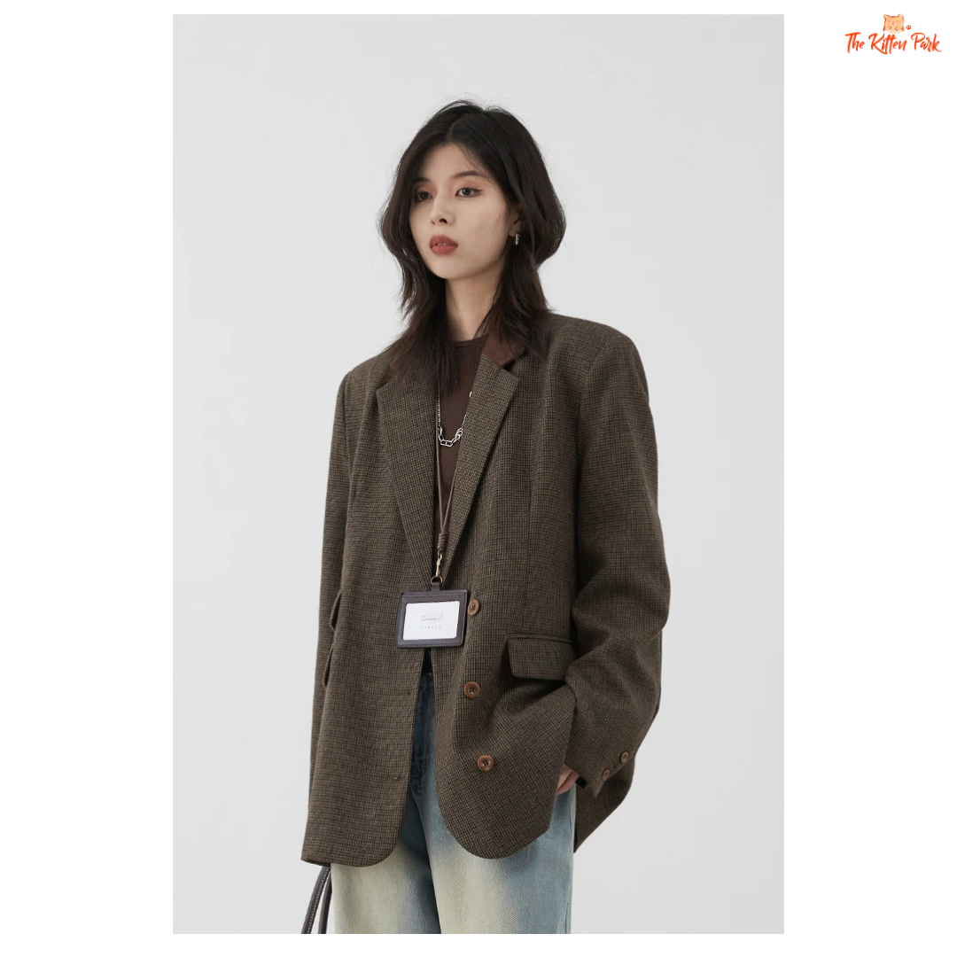 Woman wearing a brown blazer against a white background