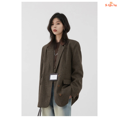 Woman wearing a brown blazer against a white background