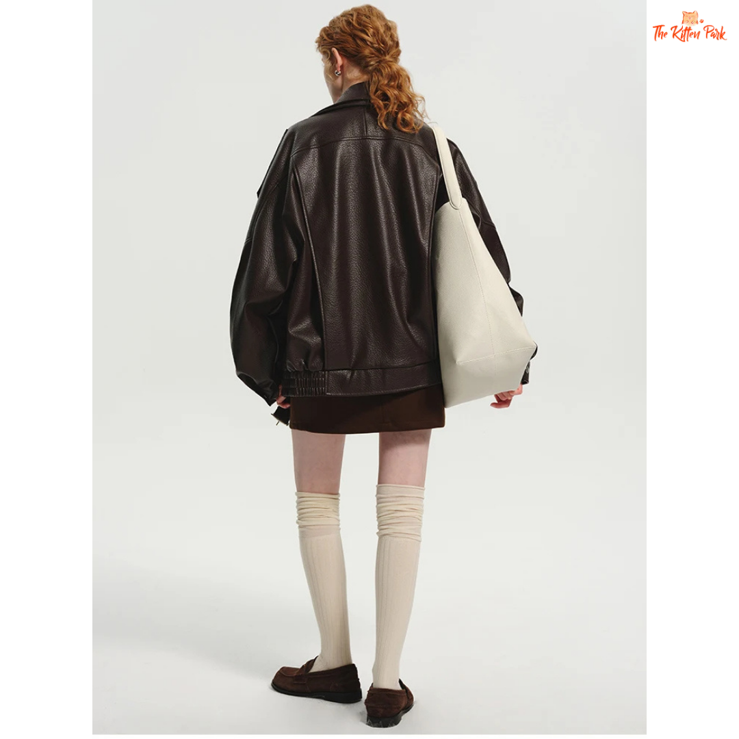 Women's oversized brown PU leather jacket with retro zip-up design, mandarin collar, and pockets — stylish high street coat for all seasons.