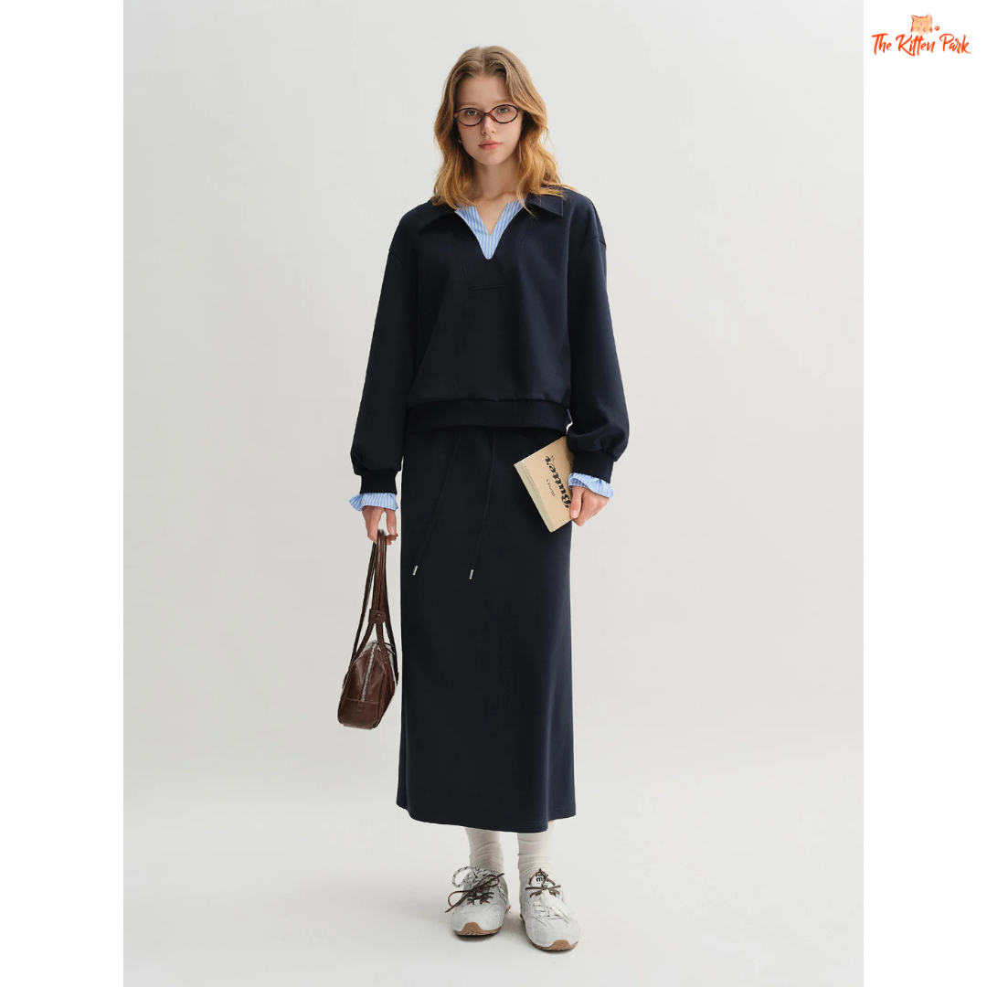 Woman wearing a navy outfit with a white background