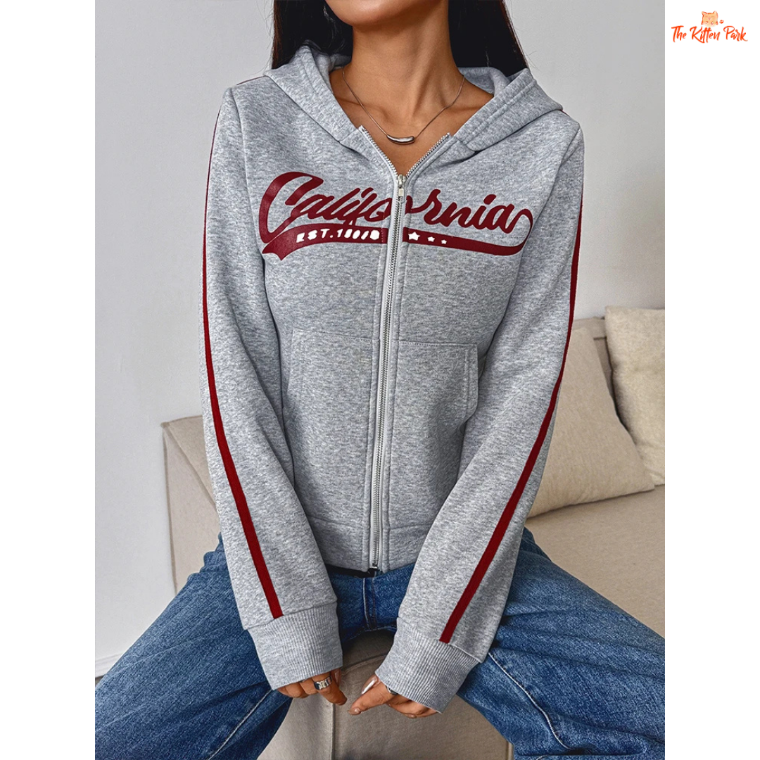 A light gray printed zipper sports hoodie for women with a hood, full zipper, and thick autumn fabric, blending sporty and streetwear style.