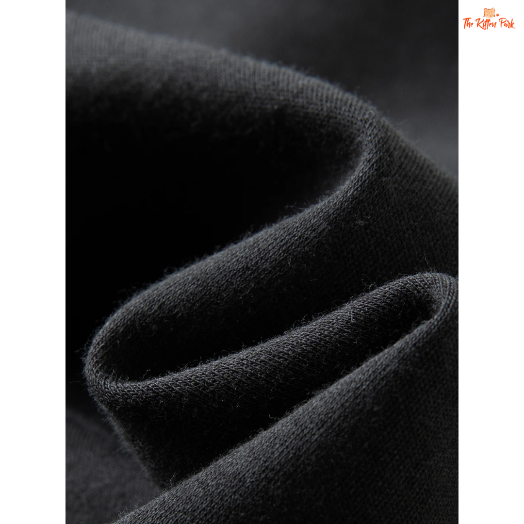 Close-up of black fabric with a textured pattern on a dark background