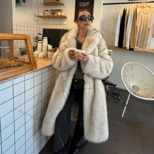 A long gradient faux fur coat for women, featuring a slouchy fit, warm lining, and vintage-inspired fur detailing for elegant winter wear.