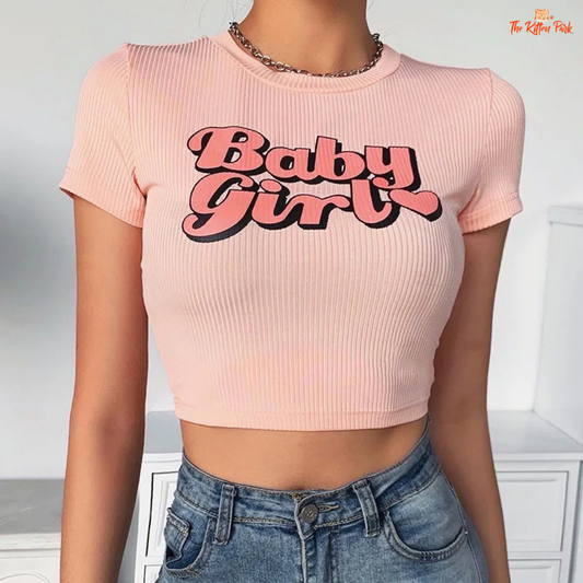 Slim-fit pink Y2K T-shirt with kawaii baby girl graphic, cropped cut, and casual style for playful spring/summer streetwear looks.