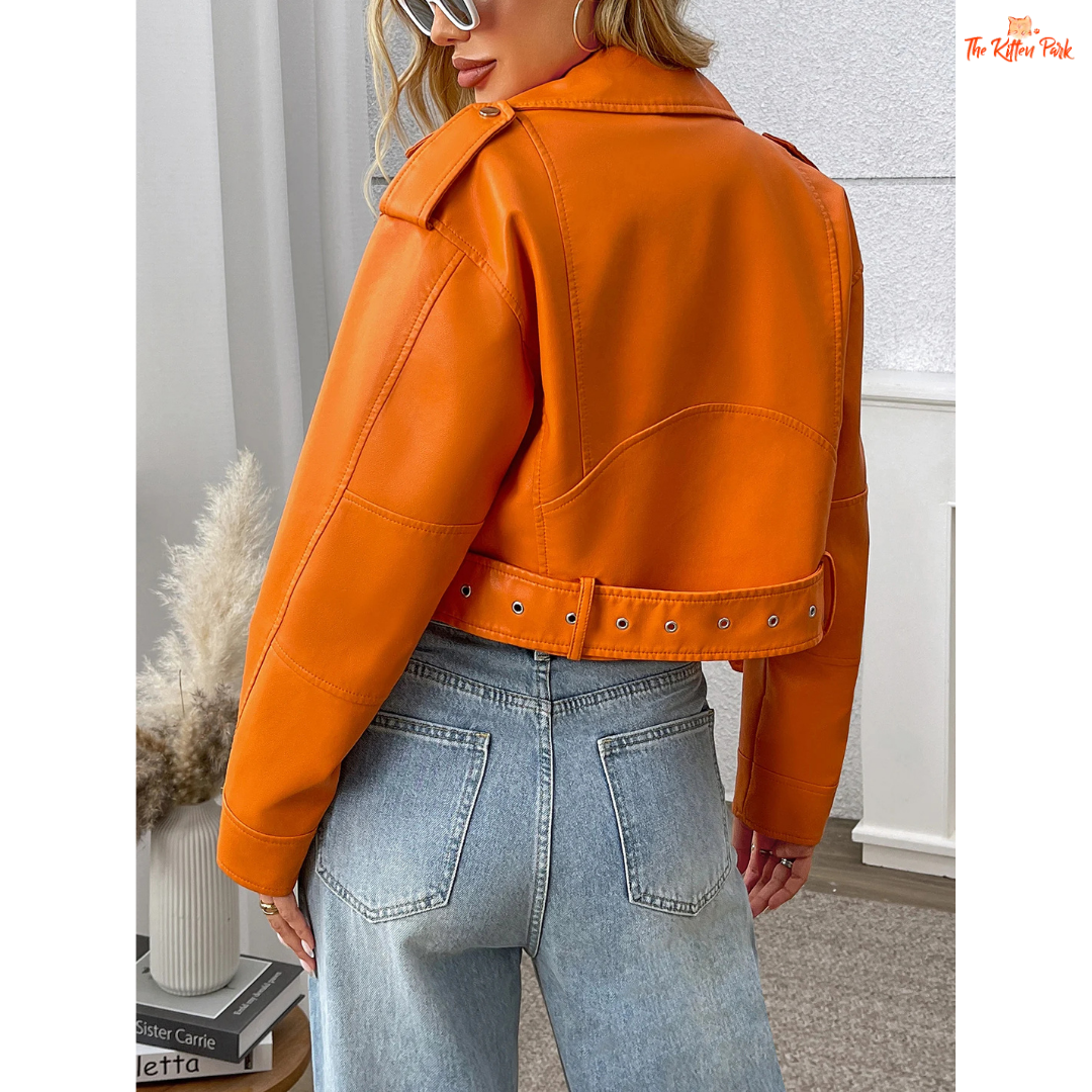 A women’s orange PU leather motorcycle jacket with lapel collar, zip closure, and casual biker style.