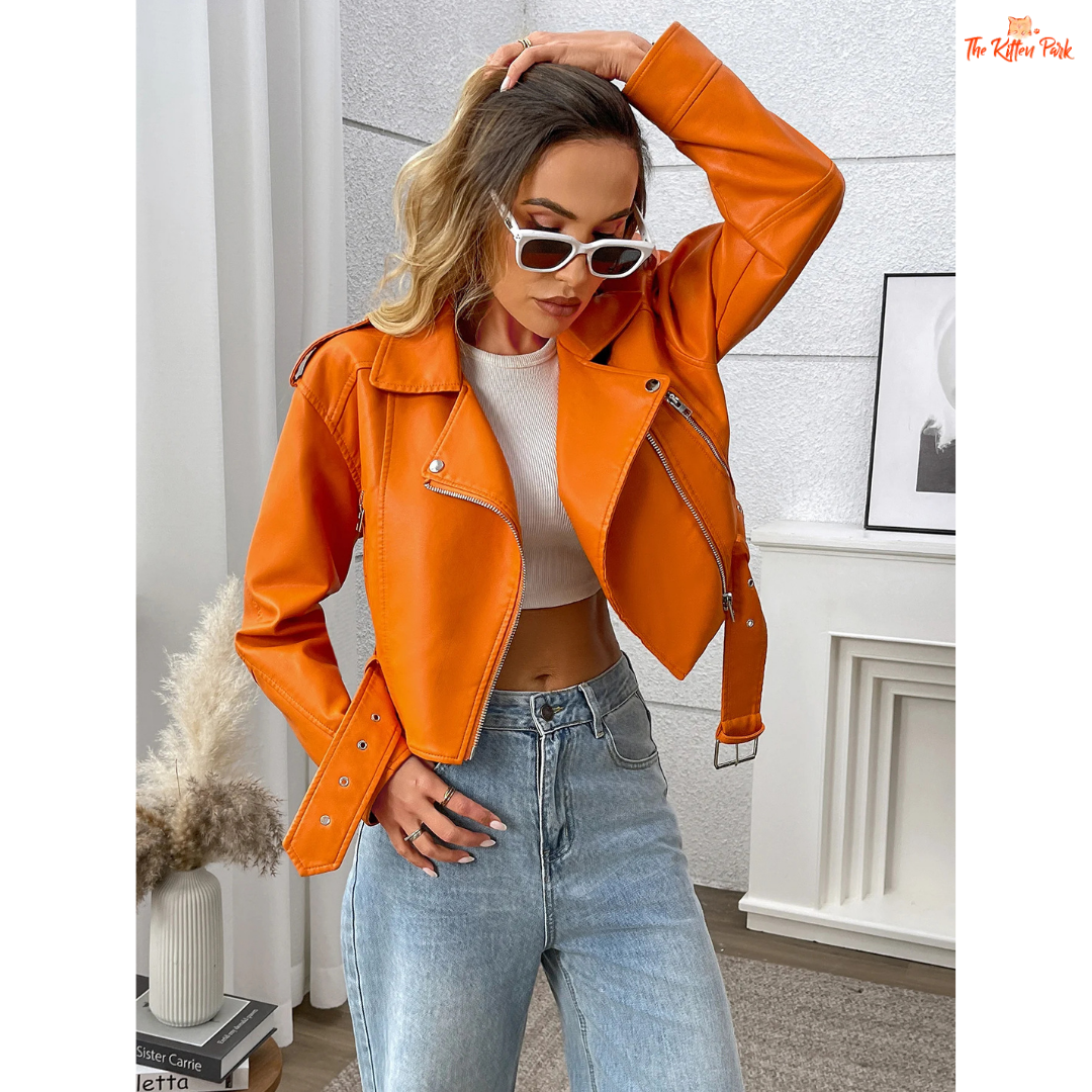 A women’s orange PU leather motorcycle jacket with lapel collar, zip closure, and casual biker style.