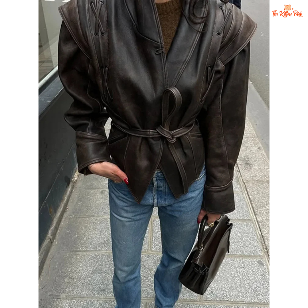 Light brown faux leather overcoat for women with belted high waist, turn-down collar, full sleeves and zipper closure — vintage high-street style for autumn/winter.