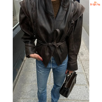 Light brown faux leather overcoat for women with belted high waist, turn-down collar, full sleeves and zipper closure — vintage high-street style for autumn/winter.
