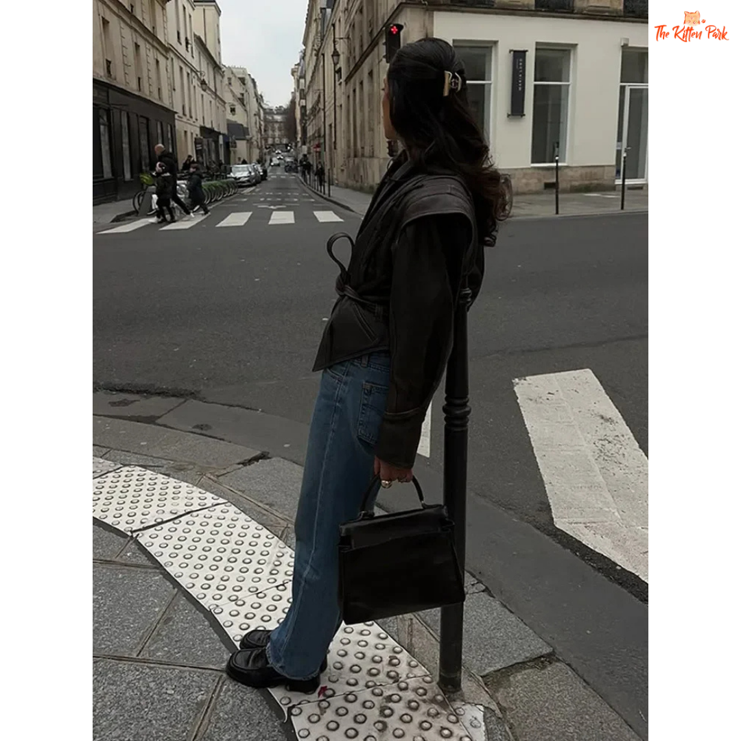 Light brown faux leather overcoat for women with belted high waist, turn-down collar, full sleeves and zipper closure — vintage high-street style for autumn/winter.