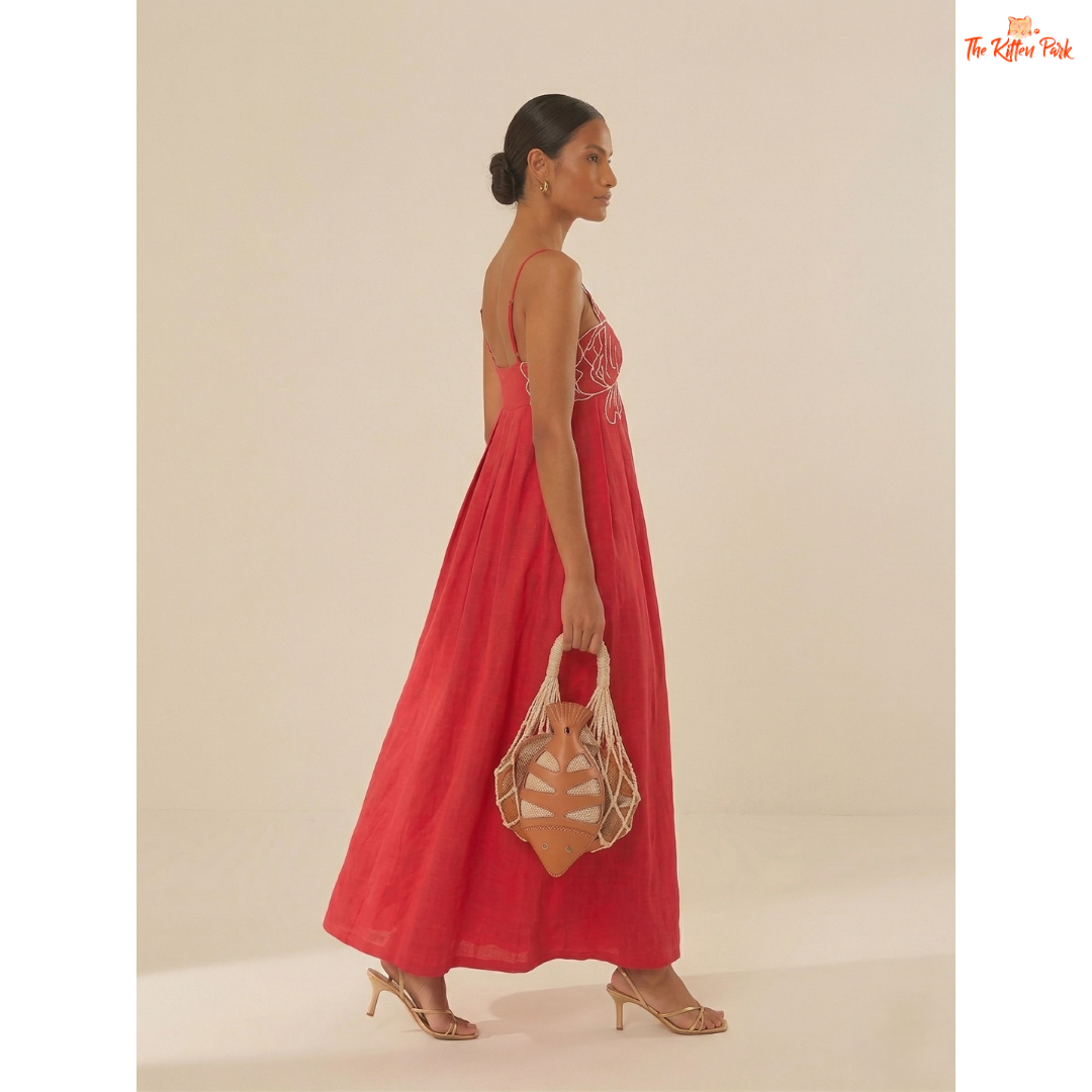 Red backless maxi dress with asymmetrical neckline, spaghetti straps, floral detail, and slim A-line summer party style.