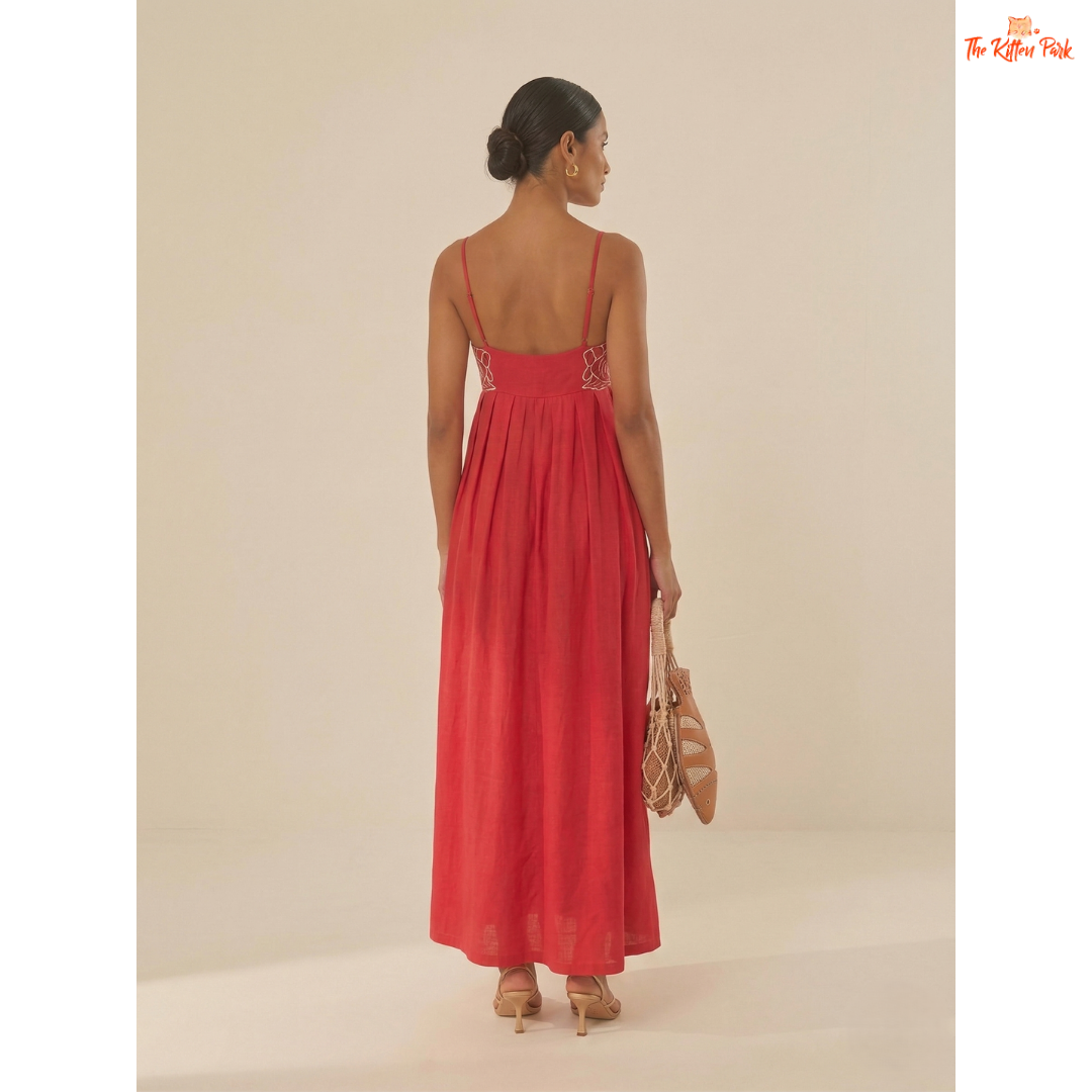 Red backless maxi dress with asymmetrical neckline, spaghetti straps, floral detail, and slim A-line summer party style.