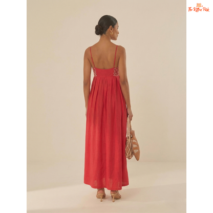 Red backless maxi dress with asymmetrical neckline, spaghetti straps, floral detail, and slim A-line summer party style.