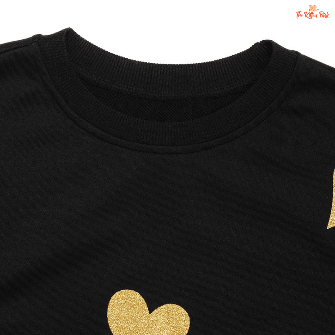 Black sweatshirt with gold heart design on a white background