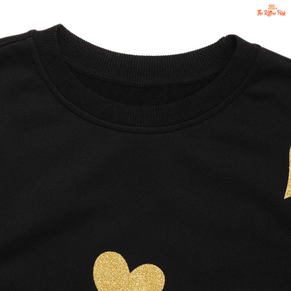 Black sweatshirt with gold heart design on a white background