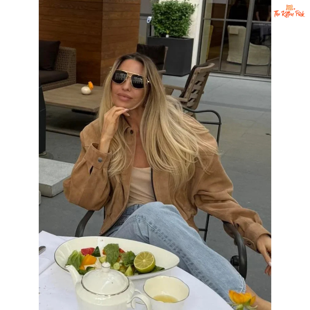 A women's camel suede cropped jacket with turn-down lapel collar, zipper closure, and pockets, designed for chic streetwear in autumn and winter.

