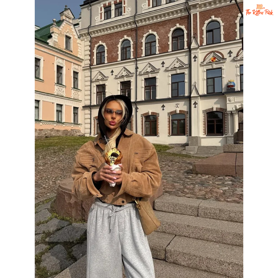 A women's camel suede cropped jacket with turn-down lapel collar, zipper closure, and pockets, designed for chic streetwear in autumn and winter.

