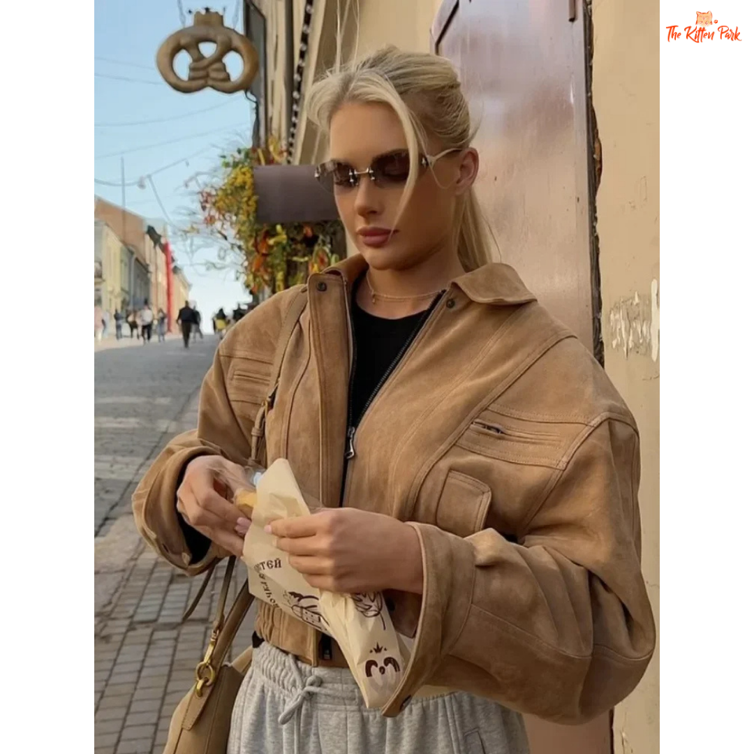 A women's camel suede cropped jacket with turn-down lapel collar, zipper closure, and pockets, designed for chic streetwear in autumn and winter.

