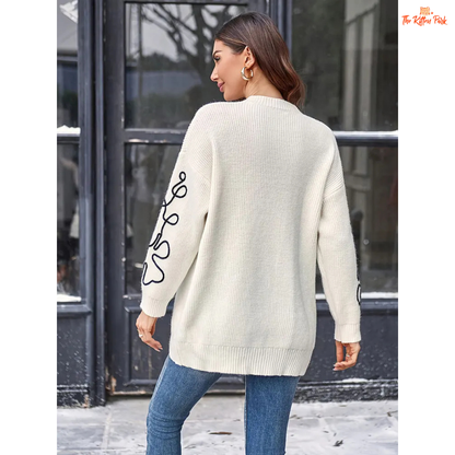Soft beige round-neck pullover sweater for women featuring floral prints, knit texture, and a loose long fit perfect for casual autumn and winter wear.