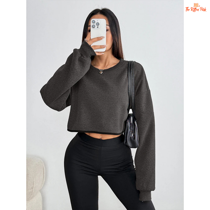 Solid O-Neck Crop T-Shirt for Women featuring a slim fit, skew collar, asymmetrical detail, and short crop design for a sleek autumn club look.
