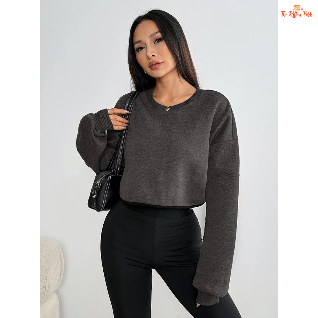 Solid O-Neck Crop T-Shirt for Women featuring a slim fit, skew collar, asymmetrical detail, and short crop design for a sleek autumn club look.